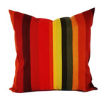 A red, orange, and brown striped outdoor pillow.