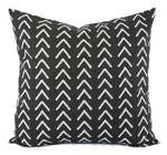 A soft black pillow with a light grey arrow print.