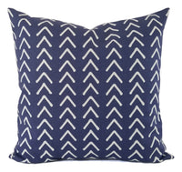 A blue pillow in a mud cloth inspired print.