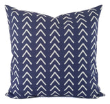 A blue pillow in a mud cloth inspired print.