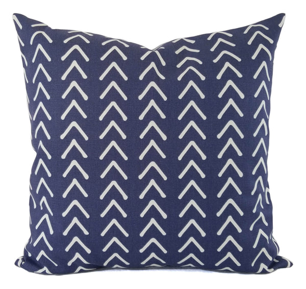 A blue pillow in a mud cloth inspired print.