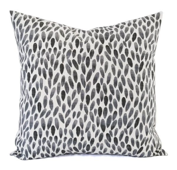 A black and soft grey pillow with a teardrop pattern.