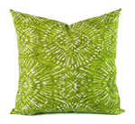 A large geometric print pillow in soft green and white.