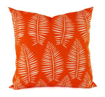 A bright orange pillow with a white leaf pattern.