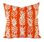 A white pineapple print on a bright orange background.