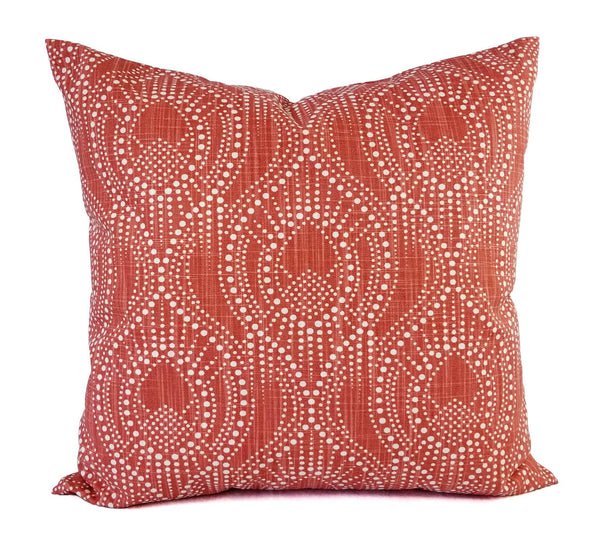 A red pillow with a white dot trellis pattern.